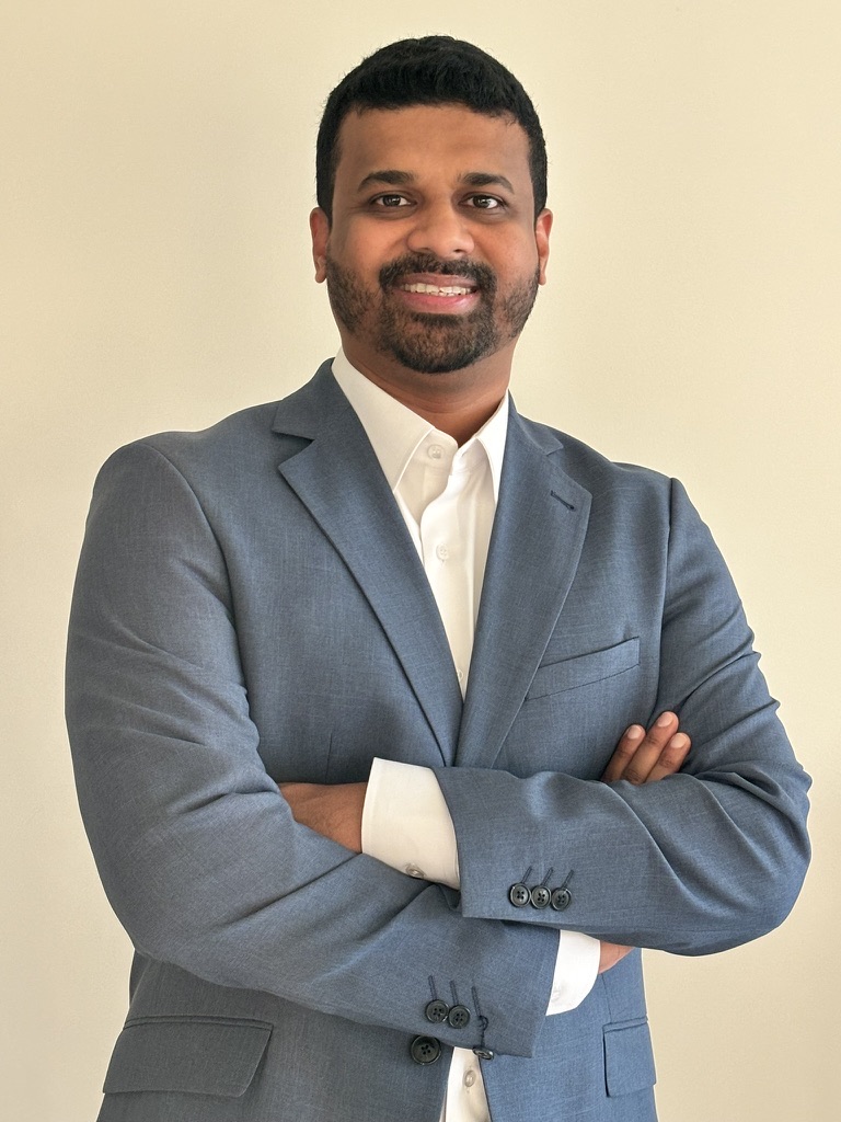 Joseph, Dubai real estate advisor, smiling with arms crossed